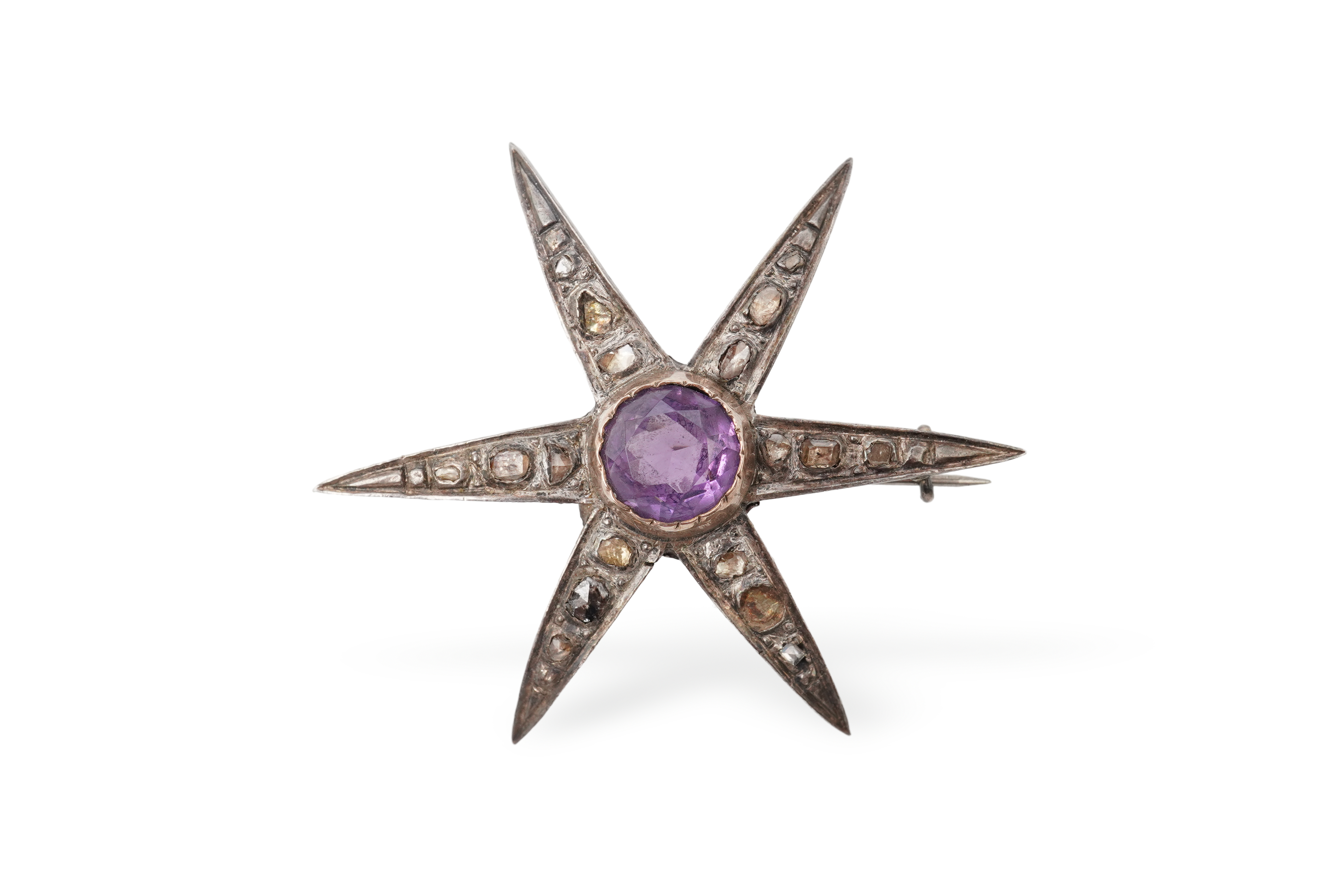 An amethyst and diamond brooch, designed as a star, set with a circular-cut amethyst and rose-cut diamonds, mounted in silver and gold, length 5.7cm, two diamonds deficient